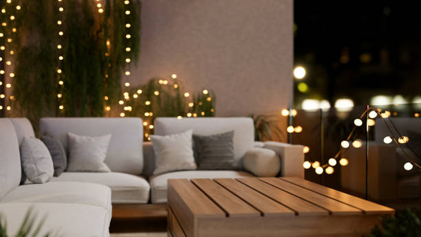 istock A cozy, beautiful apartment balcony at night, featuring a comfortable couch and glowing lights. 2189338267
