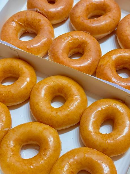 istock A classic glazed donut with a soft, fluffy texture and a sweet, glossy coating. Perfectly balanced between light and sugary, making it an irresistible treat for any time of the day. 2189339895