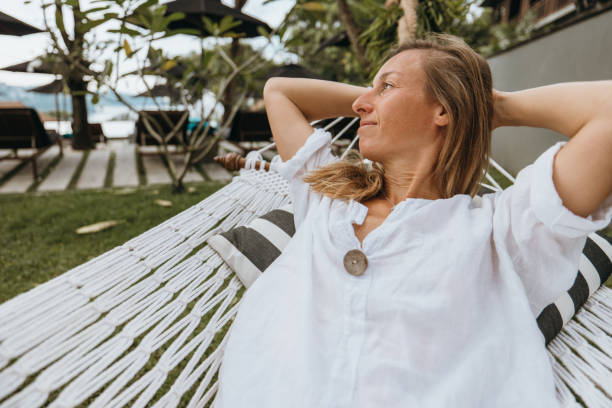 istock Woman relaxing on a hammock in a tropical resort. 2189340567