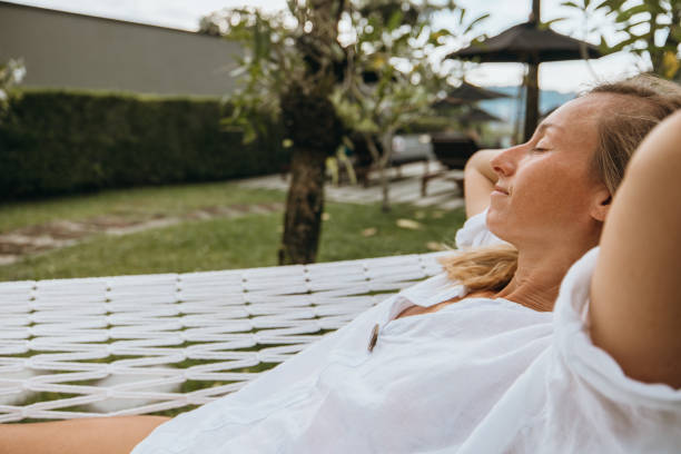 istock Woman relaxing on a hammock in a tropical resort. 2189340576