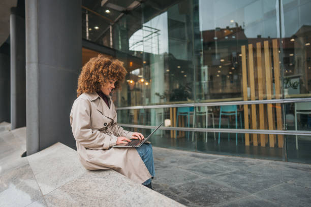 istock A young woman uses a laptop outside 2189341746