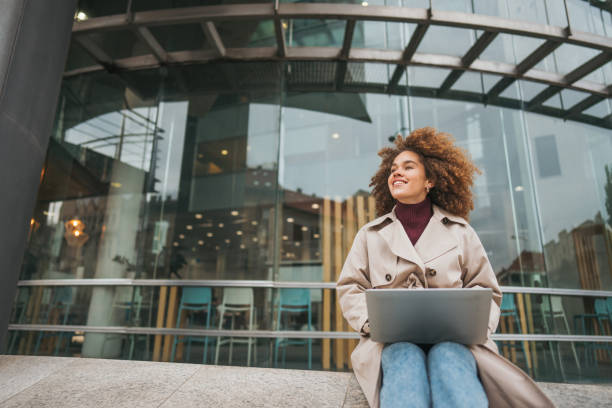 istock A young woman uses a laptop outside 2189341959