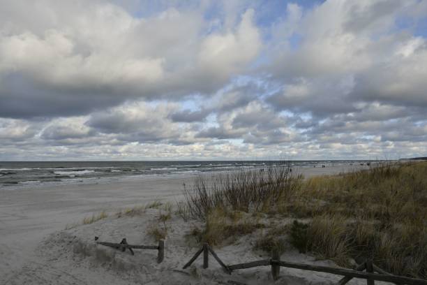 istock Scenic beach landscape with cloudy sky and dune grass. 2189342466