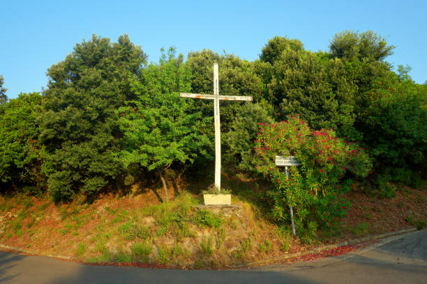 istock White catholic cross on corsica road 2189348634