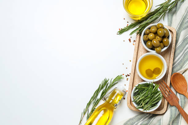istock Olive branches, oil and olives in bowls, towel on white background, space for text 2189348759