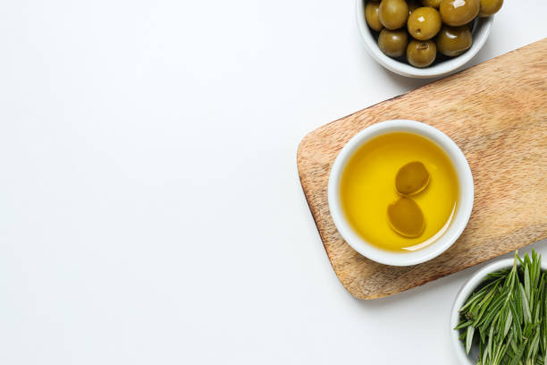 istock Olive branches, oil and olives in bowls, kitchen board on white background, space for text 2189348943