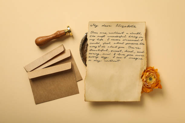 istock Vintage letter with text, envelopes, rose and stamp on beige background, top view 2189352098
