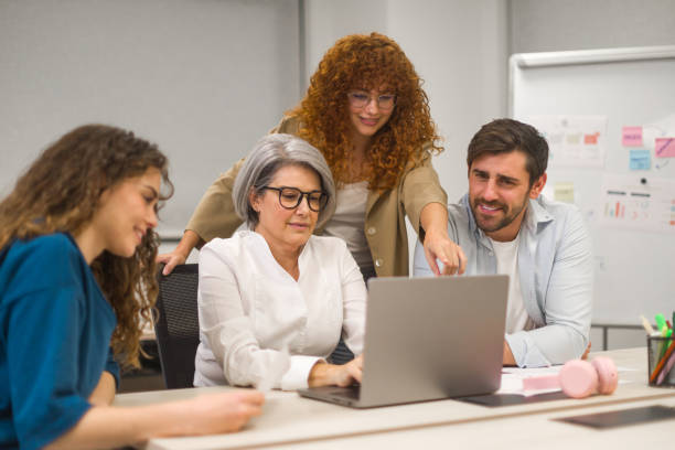 istock Business team collaborating on laptop in office meeting 2189354370