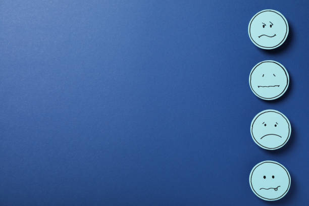 Sad emoji on dark blue background, space for text
