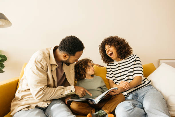 istock Family spending quality time together reading a book on the couch 2189355836