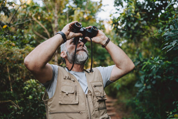 istock Portrait of a senior man observing nature with binoculars 2189356710