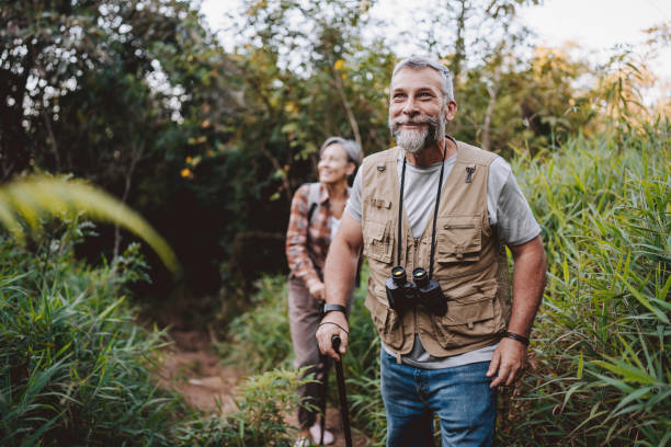 istock Senior couple walking on forest mountain trail 2189356792