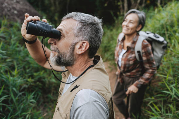 istock Senior couple observing nature with binoculars 2189356856