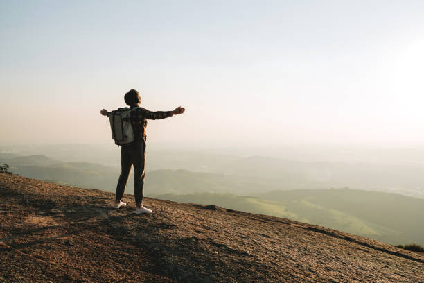istock Woman on the mountain with open arms 2189356881