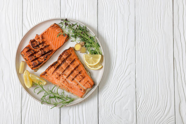 istock grilled salmon fish fillet with herbs, top view 2189357757