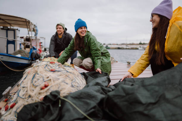 istock Fishermen preparing a boat for stormy weather 2189358165