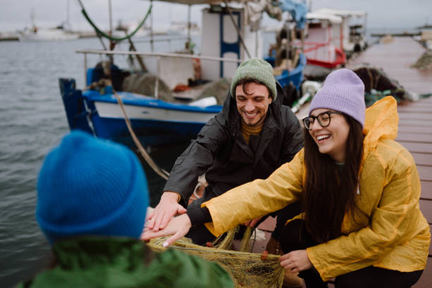 istock Fishermen preparing a boat for stormy weather 2189358247