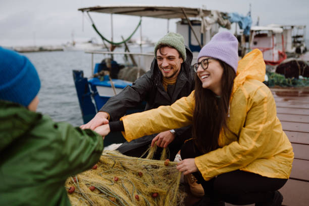 istock Fishermen preparing a boat for stormy weather 2189358291