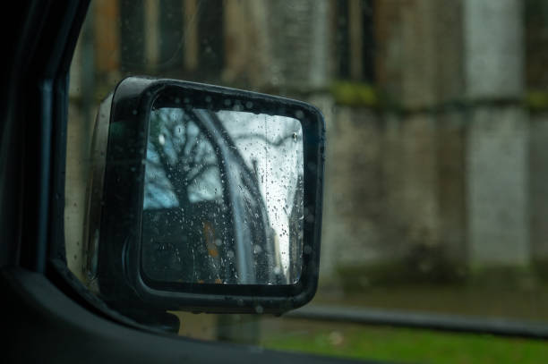 istock Rainy day reflection: old building in a car mirror 2189358555