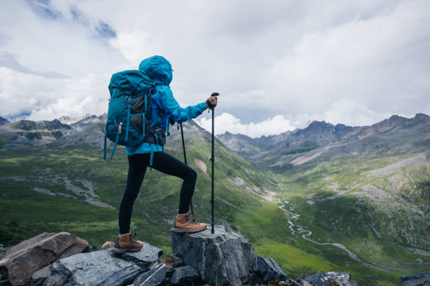 istock woman hiking on high altitude mountain top 2189358723