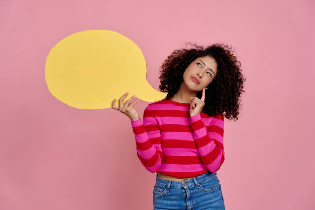 istock Young woman holding empty speech bubble and thinking about what to say 2189360880