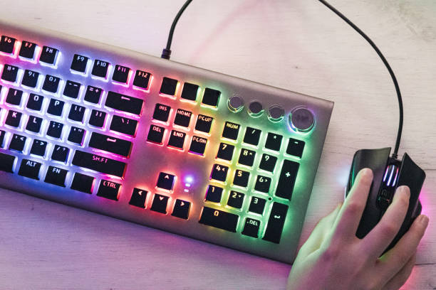 istock Close-up of boy's hands while playing computer games with RGB computer keyboard and mouse. Children gaming addiction. 2189366674