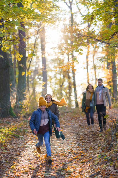 istock Kids running in the forest while their parents walking in background 2189366759