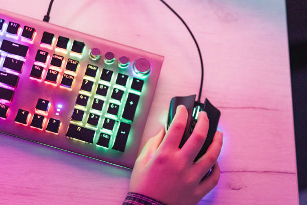 istock Close-up of boy's hands while playing computer games with RGB computer keyboard and mouse. Children gaming addiction. 2189366847