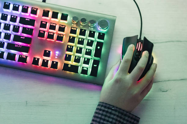 istock Close-up of boy's hands while playing computer games with RGB computer keyboard and mouse. Children gaming addiction. 2189366988