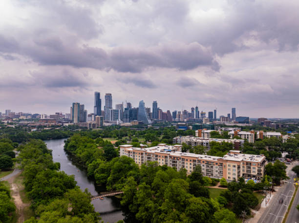 istock Austin, Texas skyline peeking through lush greenery and river, capturing the city's harmonious blend of urban and natural elements from above 2189367019