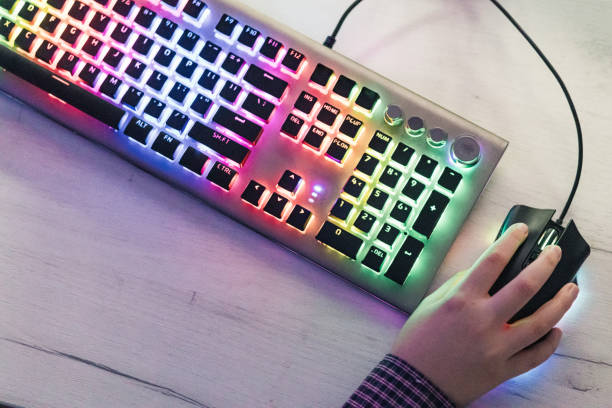 istock Close-up of boy's hands while playing computer games with RGB computer keyboard and mouse. Children gaming addiction. 2189367041