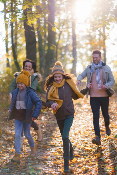 istock Parents chasing their children as they run in the forest 2189367088