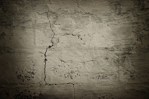 istock Textured background of old cracked cement wall with vignetting 2189369085