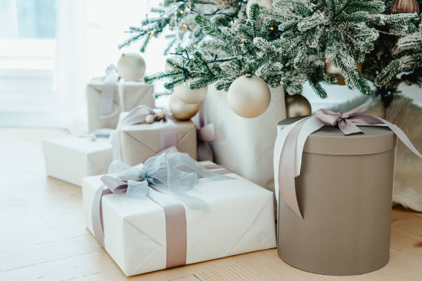istock Decorated Christmas tree with frosted branches and wrapped presents, gift boxes it in living room 2189369410