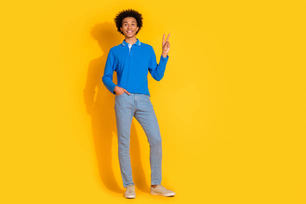 istock Full length photo of handsome young guy point empty space dressed stylish blue garment isolated on yellow color background 2189369871