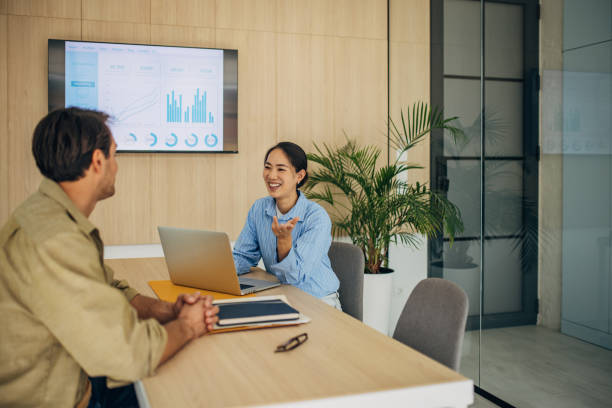 istock Smiling Professionals Engaged in a Dynamic Meeting 2189370140