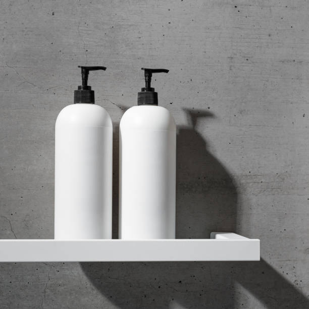 istock White bottles mock up on white shelf on gray concrete background, close up shampoo, conditioner. Aesthetic view beauty products in modern minimal bathroom neutral color. Side view, copy space 2189370961