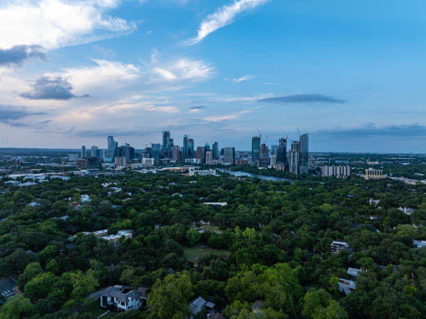 istock Austin, Texas skyline stands tall above lush greenery at dusk, showcasing coexistence of cityscape and nature under a partly cloudy sky 2189371129