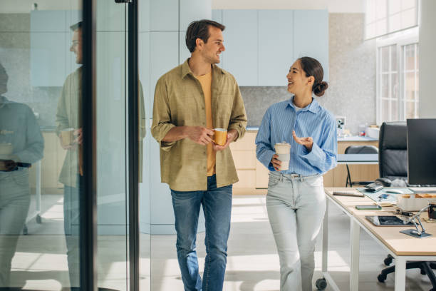 istock Couple enjoying conversation in stylish workspace 2189371516
