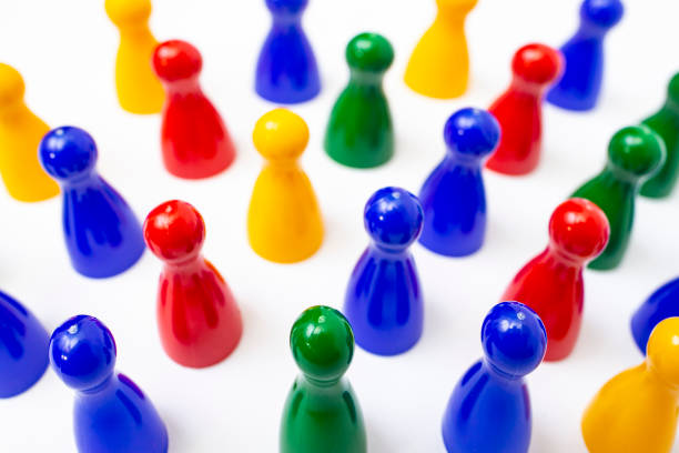 Red , yellow, blue and green pawns or pieces from a board game isolated on white background,