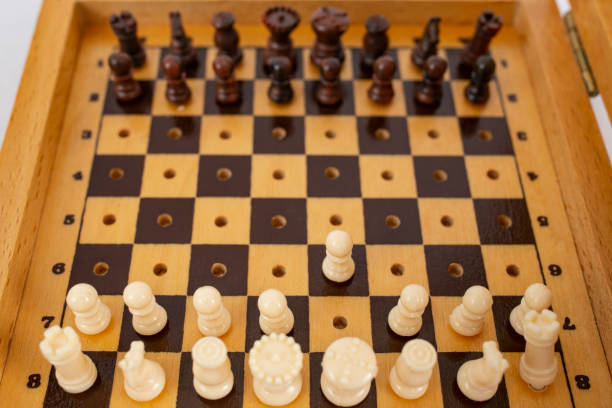 Miniature chess pieces on a pocket size chess board, soft focus
