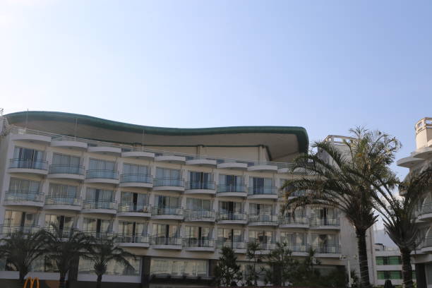 istock A large white building with a green roof and a balcony 2189377071