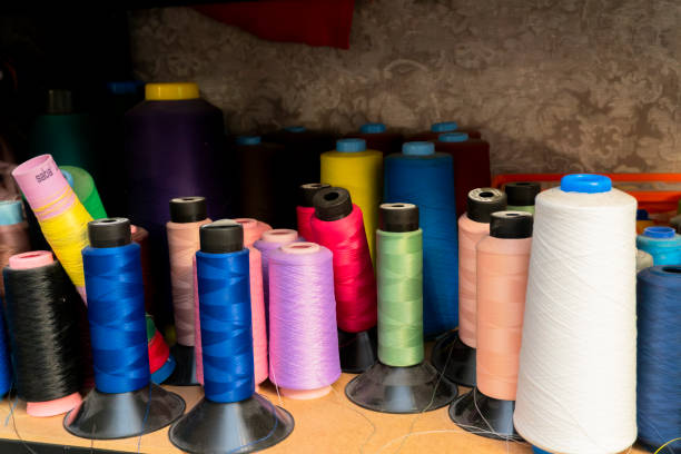 istock Variety of colorful sewing threads arranged on a table 2189377446