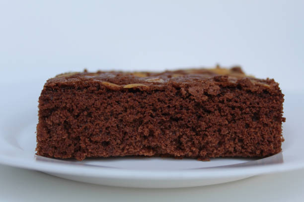 istock Brownies cake with almond topping, isolated on white background, side view 2189377607