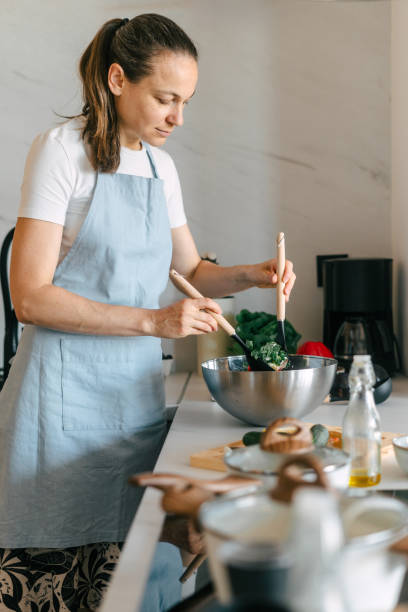 istock Woman preparing healthy meals in a bright kitchen with fresh ingredients 2189379883