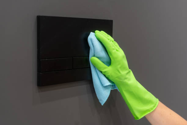 istock Woman cleaning light switch in a modern bathroom with a microfiber cloth 2189383729