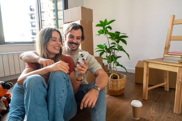 istock Couple Bonding Over a Phone in Their New Apartment 2189383891