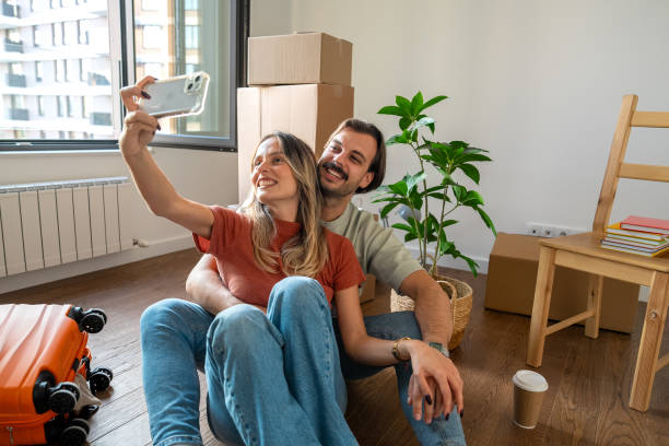 istock Young Couple Taking a Selfie in Their New Home 2189383896