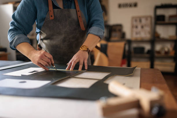 istock Skilled Craftswoman Cutting Leather 2189386297
