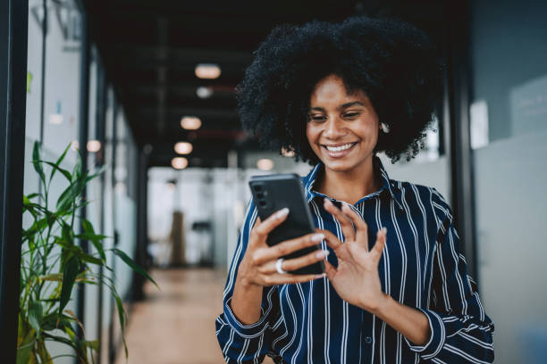istock Young businesswoman using smart phone in modern office 2189387322